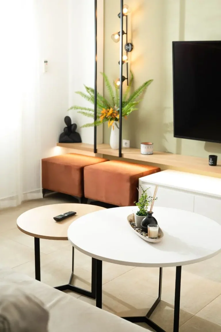 Close-up of modern round coffee tables and stylish living room decor at Ria's Apartment in Agios Nikolaos, Crete.